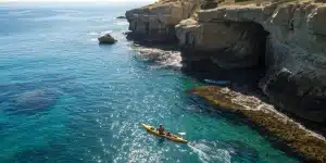 Kayakers explore La Jolla Cove's sea caves.
