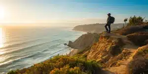San Diego coastal hiker overlooking the ocean at sunset.