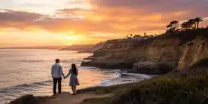 Couple enjoys sunset cliffside view during private San Diego tour.