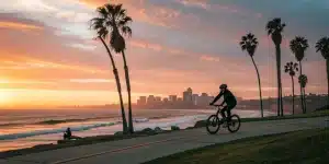 A cyclist on a San Diego e-bike tour rides along the coast at sunset.