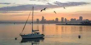 Book a private boat tour in San Diego harbor with the city skyline at sunset.