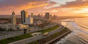 Luxury tour bus on the San Diego coastline at sunset, part of a VIP city tour package.